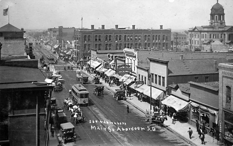 Aberdeen SD Aerial View Storefronts Old Cars Trolley Real Photo Postcard