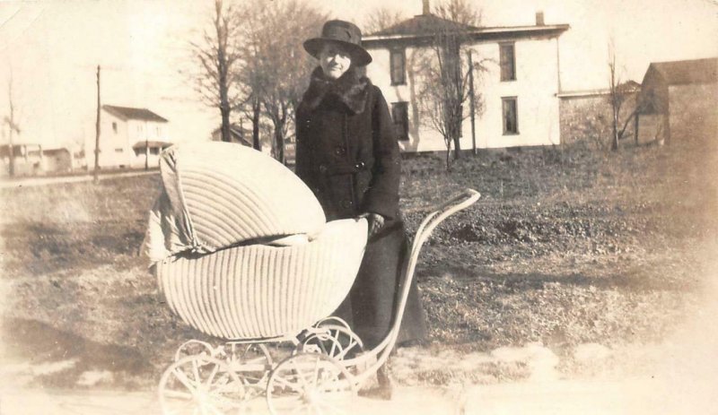 RPPC WOMAN WITH BABY STROLLER HOUSES REAL PHOTO POSTCARD (c. 1920s)
