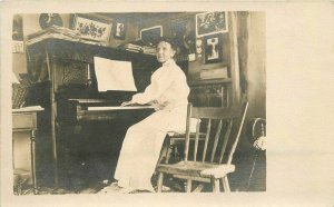 C-1910 Interior woman playing piano music RPPC Photo Postcard 20-5649