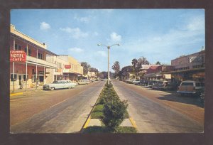 ZEPHYRHILLS FLORIDA DOWNTOWN STREET SCENE OLD CARS STORES VINTAGE POSTCARD