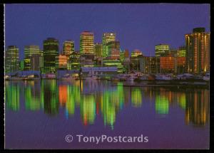 Vancouver, B.C. - The Vancouver skyline at night is reflected in the calm waters