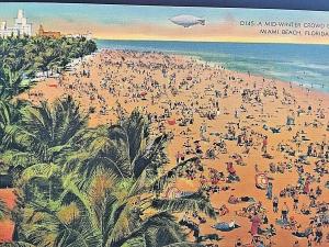 Postcard MId-Winter Crowd of Sun Bathers & Goodyear Blimp at Miami Beach, FL  W8
