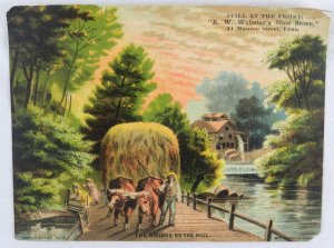 Man with Two Ox Crossing Bridge with Hay - E.W. Websters Shoe Store - Trade Card