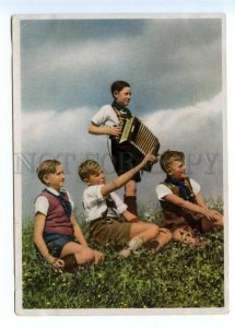 495582 East Germany GDR boy scouts playing the button accordion Vintage postcard