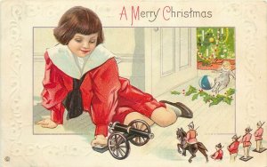 Embossed Christmas Greetings Postcard; Boy in Red with Tin Soldiers & Cannon