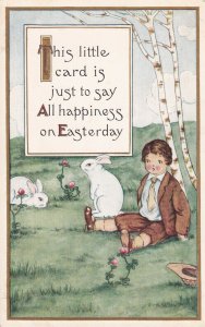 EASTER, 1900-10s; Little boy sitting by tree watching rabbits