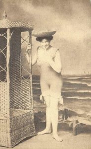 WOMAN IN BATHING SUIT AT BEACH WICKER FURNITURE RISQUE POSTCARD (c. 1910) !!