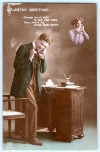 1913 RPPC VALENTINE GREETINGS HANDCOLORED ROMANTIC COUPLE ON TELEPHONES POSTCARD