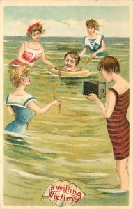 Postcard Willing Victim Man In Life Ring Surrounded By Bathing Women wIth Camera