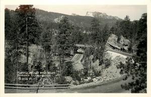 1930s RPPC Rise Photo Postcard 821 Pigtail Bridge w/ Mt. Rushmore in Background