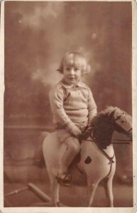 RPPC CHILD ON ROCKING HORSE STUDIO REAL PHOTO POSTCARD (c. 1910)