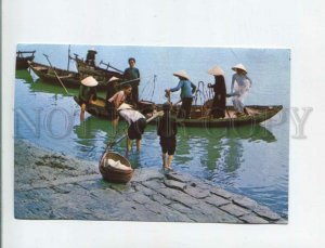 473248 South Vietnam woman unloading boats Da Nang Germany Postage Paid RPPC