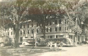 Postcard Iowa Grinnell RPPC Monroe Hotel Bus Station Buses Cook 23-1897