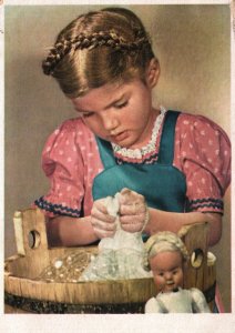 CONTINENTAL SIZE POSTCARD GIRL WITH DOLL ON SOFT PAPER DATED 1949 (E. EUROPE)