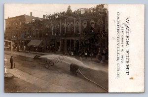 J87/ Garrettsville Ohio RPPC Postcard c1910 Water Fight Fireman Hose 1661