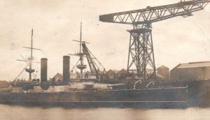 Royal Navy Battleship HMS in Harbour with Crane c1910s