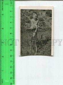 474197 USSR little boy sunbathing on a bike Vintage photo