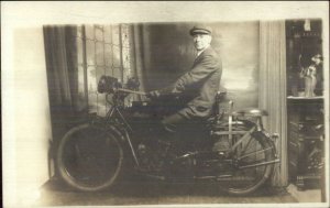 Man Sitting on Indian Motorcycle Inside Room c1920 Real Photo Postcard