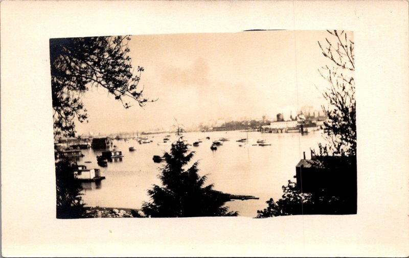 RPPC view of a harbor beach houseboats boats fishing boats industrial