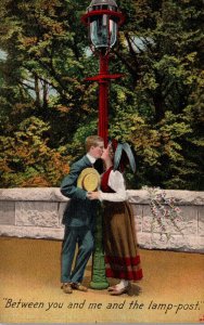 Romantic Couple Kissing Between You and Me and The Lamp Post