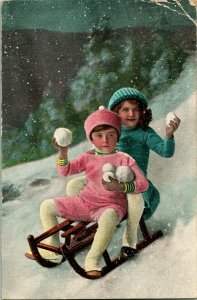 Vtg Postcard 1910 Christmas Children Riding Downhill on Sled Throwning Snowballs