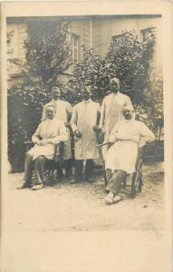 Vintage snapshot photo postcard of 5 men in white overalls ( doctors ? )