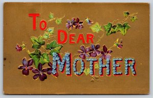 Greetings~To Dear Mother~Ivy & Violets On Gold Background~Emb~Vintage Postcard