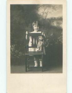 rppc Pre-1918 GIRL PUTS ANTIQUE TEDDY BEAR ON CHAIR - PROBABLY A STEIFF AC7669