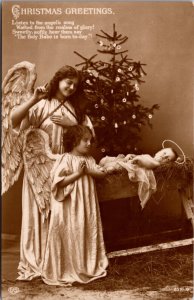 Christmas Real Photo Postcard Angel Children Looking Over Baby Jesus Tree