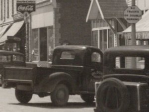 St Charles MN~Main St~1930s Cars~Olson Meat Market Truck Illegally Parked~RPPC 