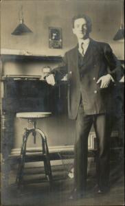 Man in Office Old Swivel Chair Trash Can Lamps 1908 Real Photo Postcard