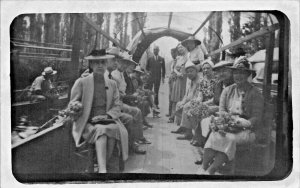 PEOPLE CARRYING FLOWERS RIDING TRAJINERAS POSSIBLY IN MEXICO~REAL PHOTO POSTCARD
