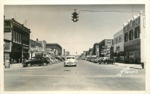 Postcard RPPC Montana 1950s Kalispell Street Scene Automobiles 23-6063