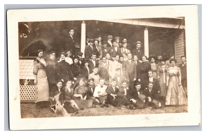 Postcard Large Group Of Men And Women Posing In Front Of Old House RPPC 