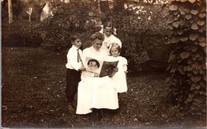 Real Photo Postcard Three Children with Mother Reading a Magazine Corn Flakes Ad