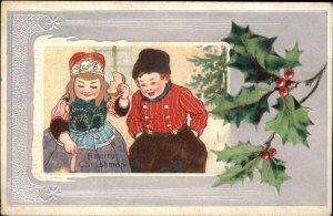 Christmas Dutch Children Boy and Girl with Doll Holly Border c1910 Postcard