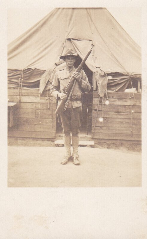 Military World War I Era Soldier With Rifle Standing in Front Of Tent Real Photo