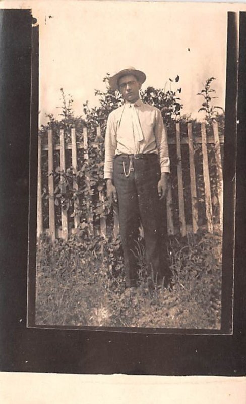 Man next to fence Writing on back 