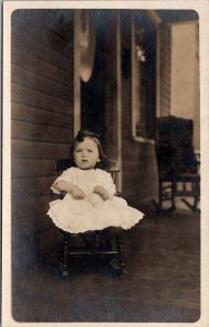 RPPC Cutie Little Girl Curious Face Rocking Chair on Porch Postcard G25