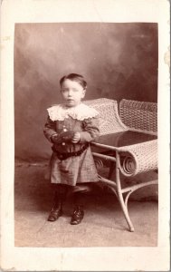 Real Photo Postcard Little Boy in a Photo Studio with Wicker Chair