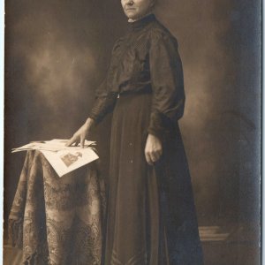 c1910s Concerned Lady Reading Newspaper? RPPC Woman Portrait Real Photo Odd A160