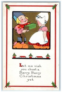 c1910's Christmas Dutch Kid Giving Gift Holly Berries Embossed Antique Postcard