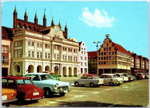 VINTAGE CONTINENTAL SIZE POSTCARD 1960s CARS PARKED AT CITY HALL ROSTOCK GERMANY