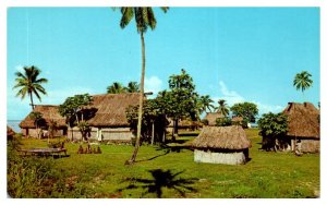 Fijian Village built near a stream and beside the sea Fiji Postcard