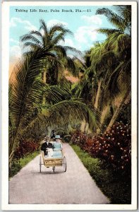 Couple Ride In Between Beautiful Palm Lined Roadway Palm Beach Florida Postcard