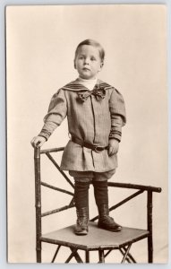 RPPC Edwardian Toddler~Chambray Sailor Outfit~Bowtie~Low-Set Belt~Cane Chair