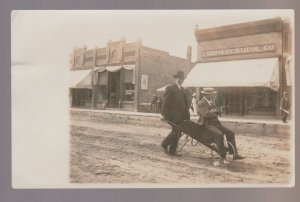 Dows IOWA RPPC c1910 ELECTION BET Main Street MAN PUSHING WHEELBARROW Free Ride!