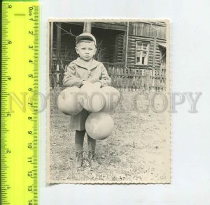 452286 USSR boy with balloons near the wooden house Old photo