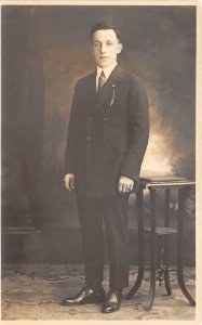 c1910 RPPC Real Photo Postcard Young Well Dress Man In Suit & Tie Standing Table