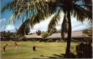 Hotel Hana-Maui - guests golfing on lawn in front of Hanahou cottages